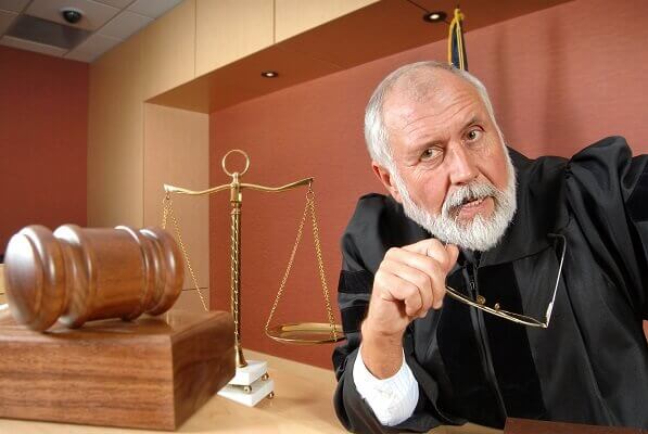 judge listening to aggressive lawyer